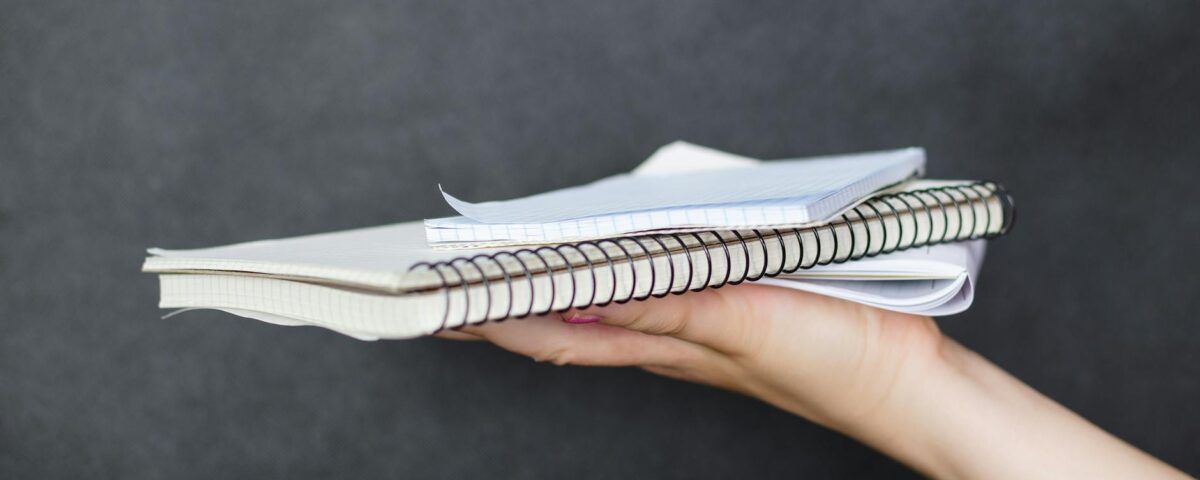 person holding notebook