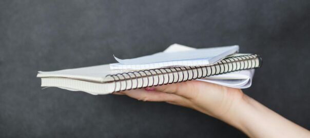 person holding notebook